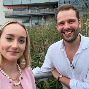 Hettie Jago with husband, stand together in front of a building, both looking at the camera with cheerful expressions.