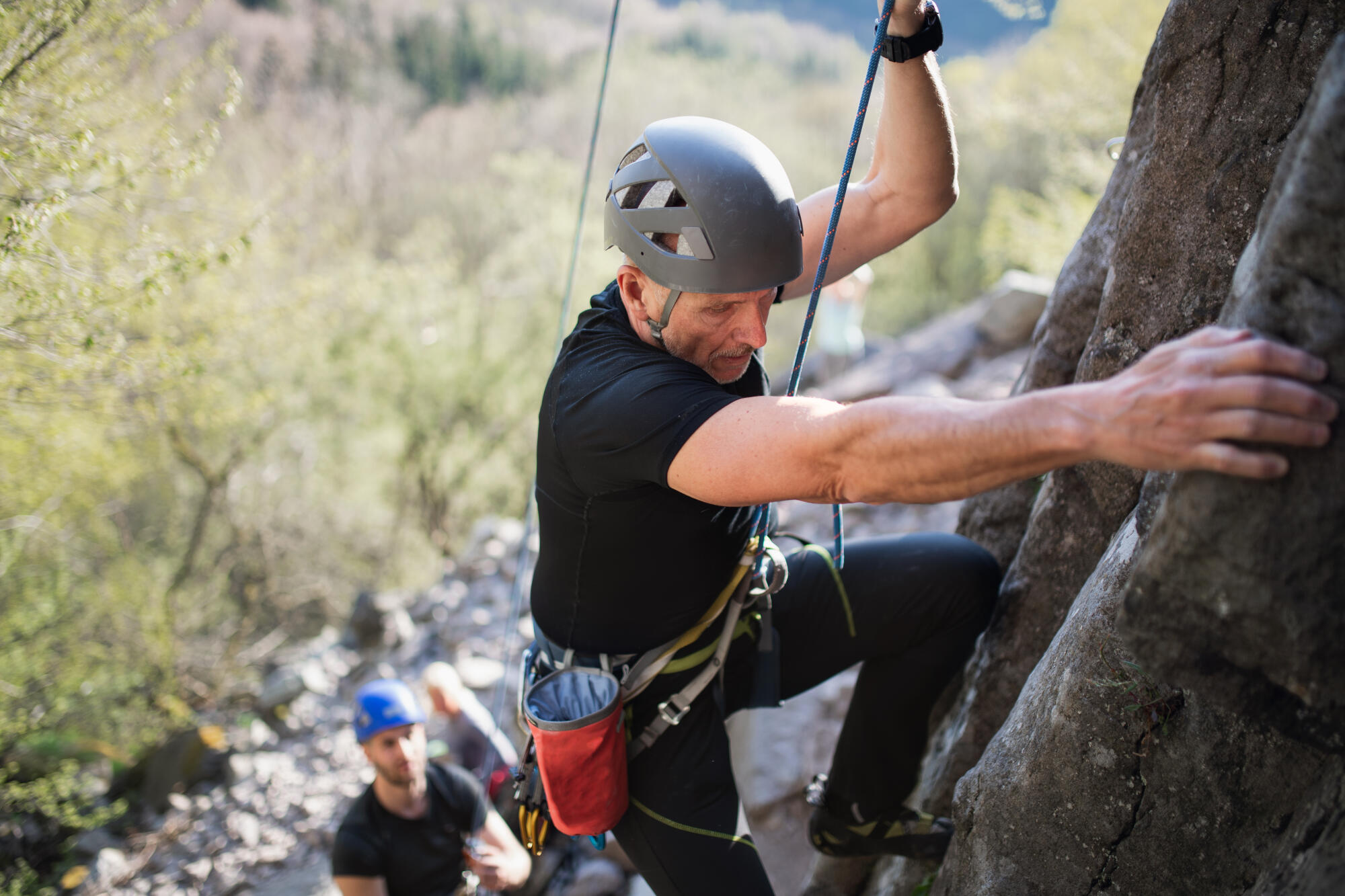 Senior,Man,With,Instructor,Climbing,Rocks,Outdoors,In,Nature,,Active