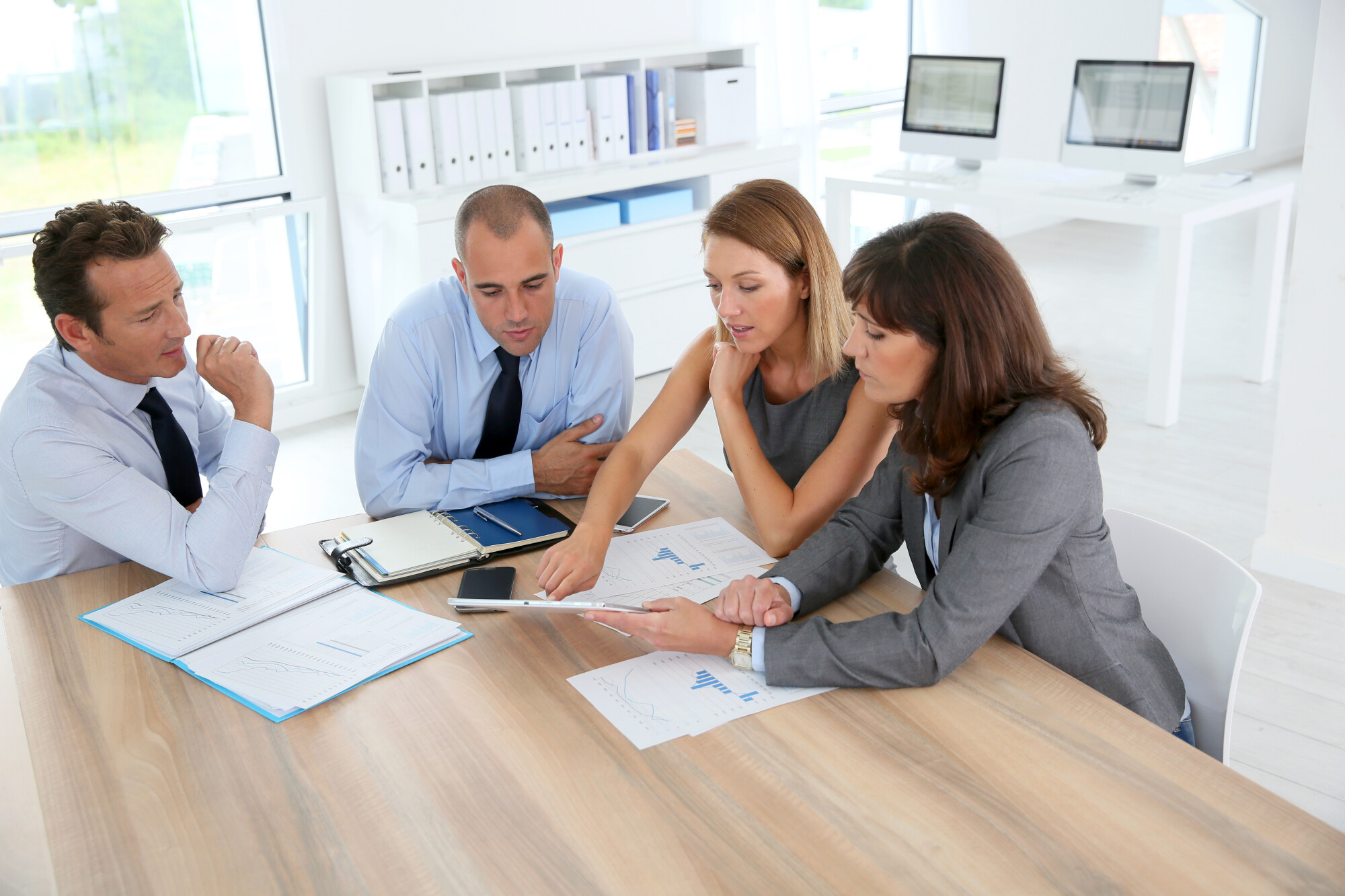 Group,Of,Business,People,Meeting,Around,Table,With,Tablet
