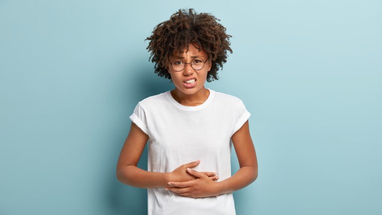 Dissatisfied,Young,Woman,Has,Food,Poisoning,,Keeps,Hands,On,Belly,